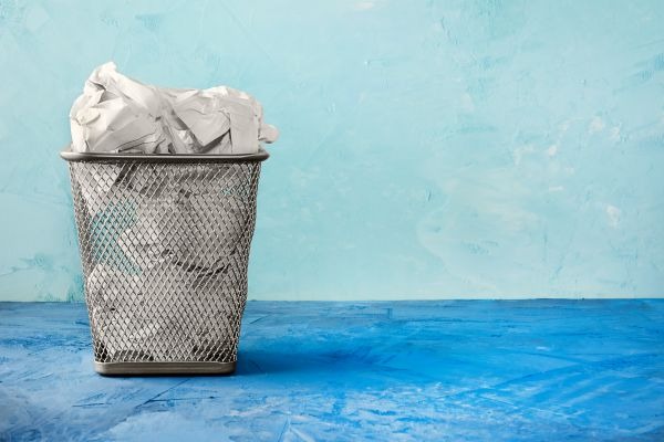 A wastepaper basket with blue background