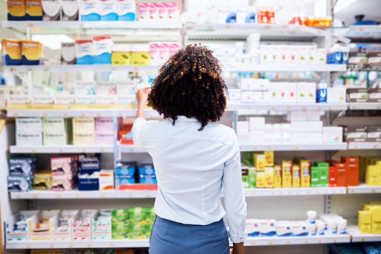 Rearview shot of a young woman looking at products in a pharmacy. The Honey Pot targets women in a creative way with their messaging, ads and social media.